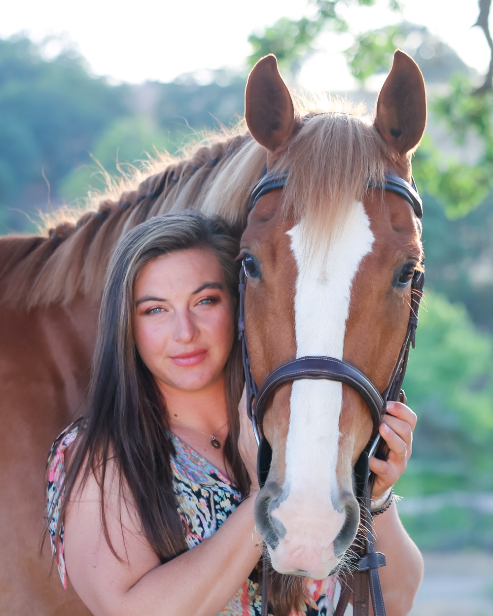 Kacie Doyle standing with a chestnut horse